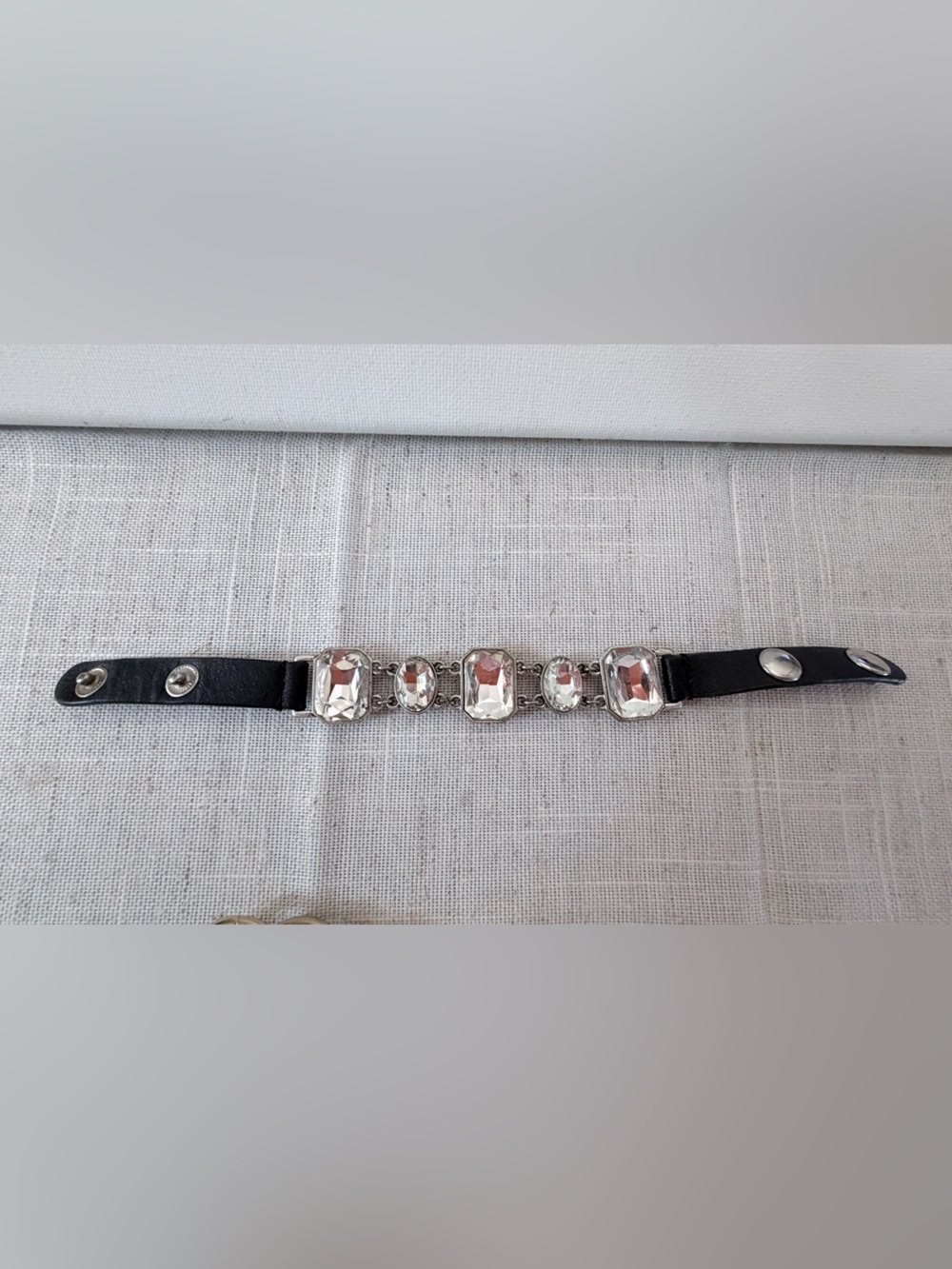 black Guang Tong bracelet features clear rhinestone stones in various shape